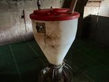 a red and white bucket sitting on top of a metal stand