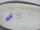 porcelain figurine of a woman with a blue and purple design