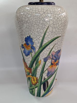 an image of a vase with flowers painted on it