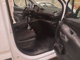 a white van with the door open and the driver ' s seat down
