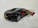a black toy car with a door open on a white surface