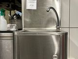 a stainless steel sink in the middle of a kitchen