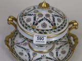 an image of a white and gold plate with a lid on it