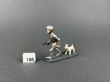 toy figurine of a man on a snowboard with a dog