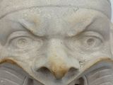 a stone sculpture of a man with a mouth open