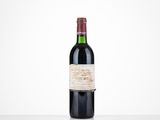 a bottle of red wine sitting on top of a table