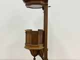 a wooden clock on a stand on a wooden floor