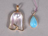 an image of two pendants with a tear shaped pendant and a tear shaped pendant with a tear shaped pendant
