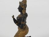 an image of a statue of a woman sitting on a rock