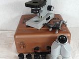 a brown suitcase with a microscope on top of it