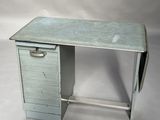 a small desk with a drawer on top of it