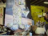 a picture of a man taking a picture of a bottle of wine and oysters