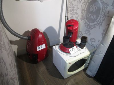a red vacuum and a white microwave on the floor