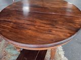 a wooden table with chairs around it in a room