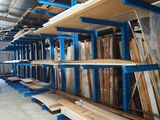 many shelves that are in a warehouse with wood and metal
