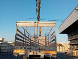 a truck that is driving down the street with a crane on it ' s back