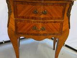 a small wooden table with a marble top on it