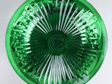 a green glass bowl with a white stripe on it