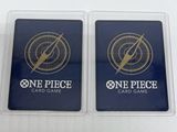 a pair of one piece card game cards in plastic cases