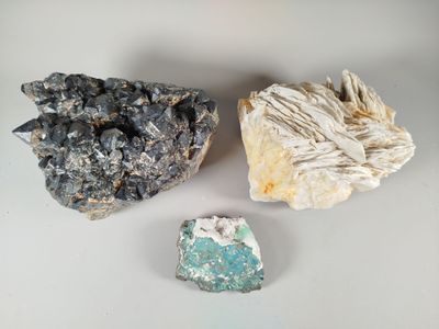three different types of rocks on a table with a white background