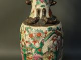 a vase with a design on it sitting on a table