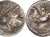 a silver coin with an image of a man riding a horse