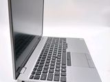 a silver laptop computer sitting on top of a white table