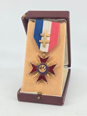 an image of a medal in a box with a cross on it