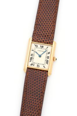 a lady ' s cartier watch with a brown leather strap