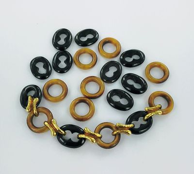 a close up of a bracelet with black and brown beads