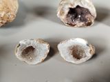 three different types of rocks on a white surface
