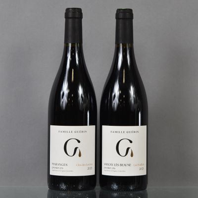 two bottles of wine sitting on top of a table next to each other