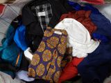 a pile of clothes in a basket on the floor