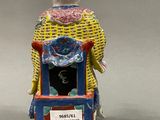 a figurine of a woman sitting on a chair