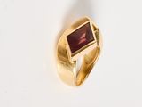 an image of a gold ring with a garnet stone in it