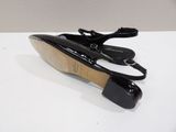 pair of women ' s black shoes on a white surface
