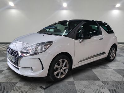 the small white car is parked on a checkered tile floor