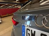a car that is parked in a garage with other cars in the background