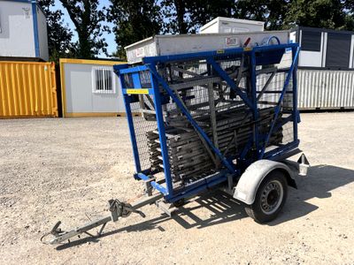 a small trailer with a trailer attached to it in the dirt