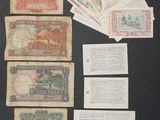 a bunch of old paper money sitting on top of a table