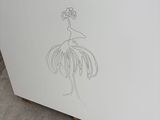 a drawing of a flower on a piece of paper on the ground