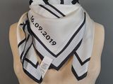 black and white square scarf on mannequin torso with name tag