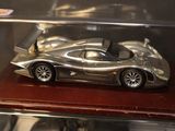 a silver model of a race car in a display case