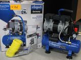 two air compressors sitting next to each other on the floor