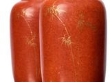 two vases that are sitting on a table