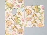 two pieces of fabric with floral designs on them on a blue surface