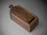 an old wooden box with a wooden handle on a gray surface