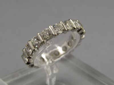 a close up of a diamond ring on a clear surface