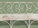 a white bench that is sitting on a green surface