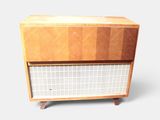 a small wooden cabinet with a white grid pattern on it